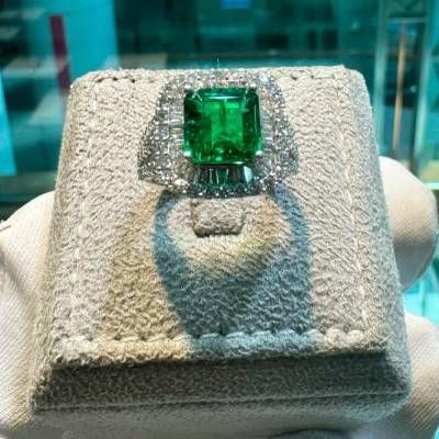 Magnificent Emerald and Diamond Halo Ring in 18K White Gold